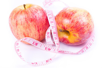 Apple and measuring tape isolated on white background.
