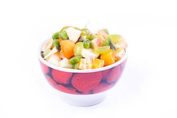 Plate of a tasty cuted fruits isolated on a white background.
