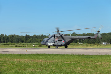 The military helicopter at the airfield preparing for take-off