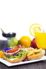 Hamburger with fries on wooden table
