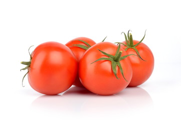 Four red deliciuos tomatoes isolated on white