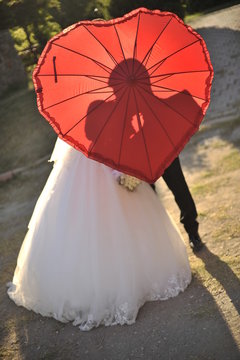 Bride and Bridgroom under the umbrella