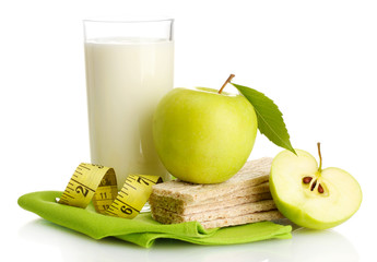 Glass of kefir, green apples, crispbreads and measuring tape