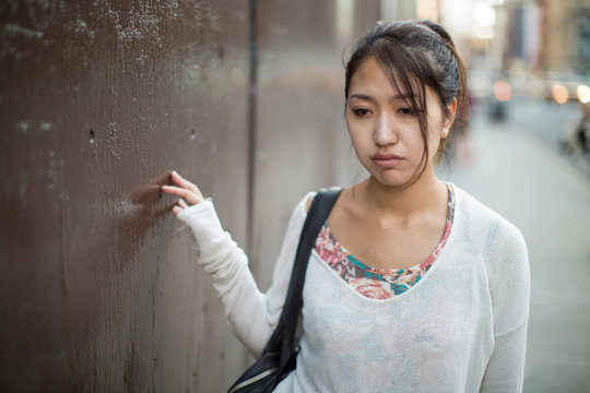 Asian woman walking depressed sad