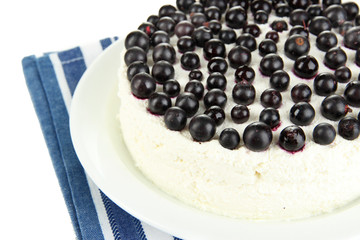 Cheesecake with fresh berries on white plate closeup