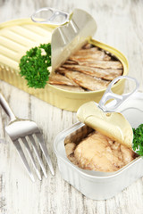 Open tin can, on wooden background