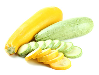 Sliced and whole raw zucchini, isolated on white