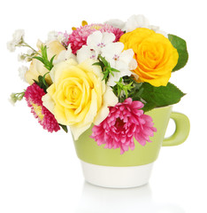 Beautiful bouquet of bright flowers in color mug, isolated