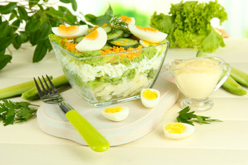 Delicious salad with eggs, cabbage and cucumbers on wooden