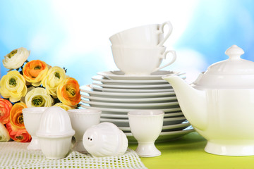 Lots beautiful dishes on wooden table on natural background