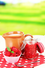 Fresh raspberry, raspberry jam and cream in jug