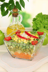 Tasty salad with fresh vegetables on wooden table