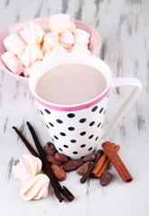 Cocoa drink  with spices and zephyr on wooden background