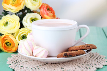 Cocoa drink on wooden  table, on bright background