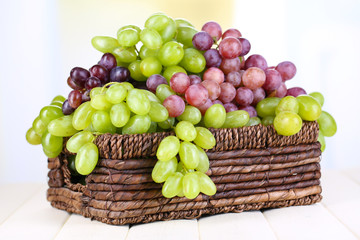 Ripe green and purple grapes in basket