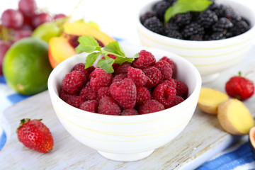 Raspberries and blackberry in small bowls