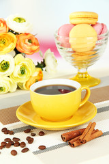 Coffee and macaroons on table on light background