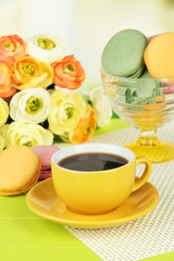 Coffee and macaroons on table on light background