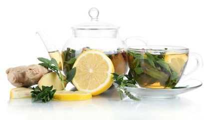 Kettle and cup of tea with ginger isolated on white