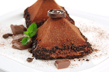 Delicious chocolate cakes on plate close-up