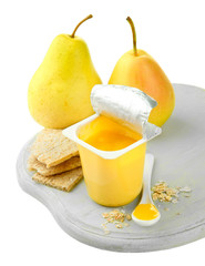 Tasty yogurt in open plastic cup, cookies and fruit,