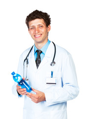 Portrait of a smiling male doctor holding bottle of water on whi