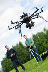 Engineers Operating UAV Octocopter in Park