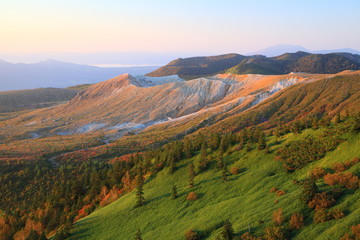 Fototapeta premium Mt. Kusatsu-Shirane glows in the morning sun, Japan