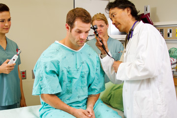 Doctor performing ear exam