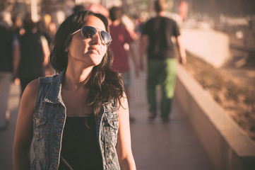 Young brunette woman walking on the street