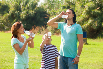 Fototapeta premium parents with teenager drinking from bottles