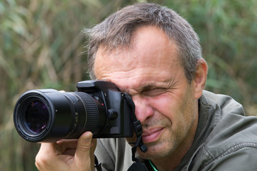 Photographer in action in forest