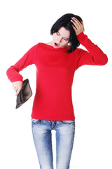 Young woman shows her empty wallet.
