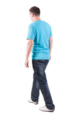 Obraz premium Back view of walking handsome man in t-shirt.