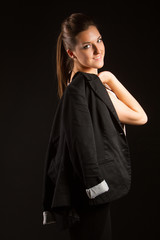 Portrait of beautiful woman posing in studio with jacket