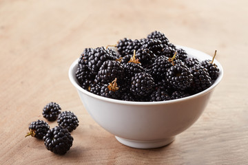 Bowl of blackberries on table