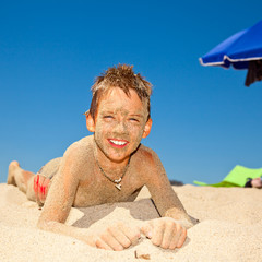Sandy boy on a beach