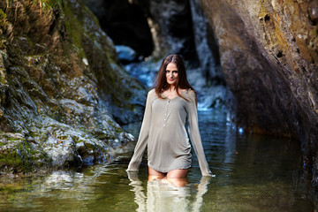 Sexy young woman standing in water