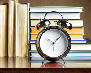 Alarm clock and books. Education concept