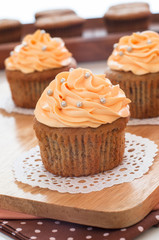 Homemade cupcakes served on kitchen table.