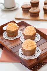 Homemade cupcakes served on kitchen table.