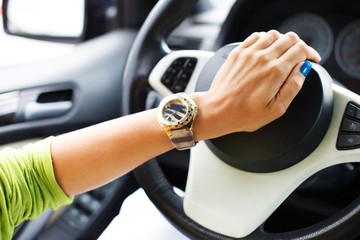 Woman hand pressing on a car horn