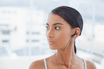 Pensive pretty model listening to music