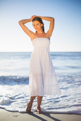 Beautiful woman in white summer dress posing