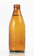 BOTTLE OF ICE COLD BEER ISOLATED ON WHITE BACKGROUND