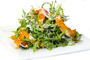 salad of arugula figs and cheese on white background
