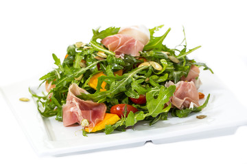 salad of arugula ham cheese on a white background