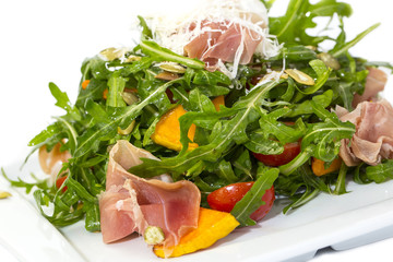 salad of arugula ham cheese on a white background