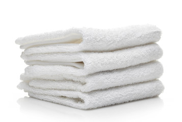 Stack of white hotel towels on a white background