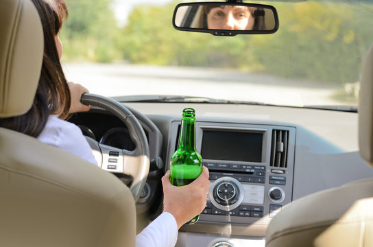 Woman drinking alcohol and driving